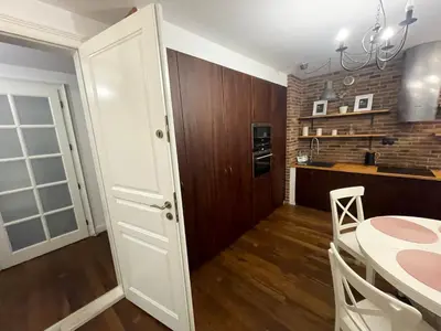 a kitchen and dining room with a table and a dining room at Royal Oak - 3BD 2BA apartment with parking and river view in Kraków