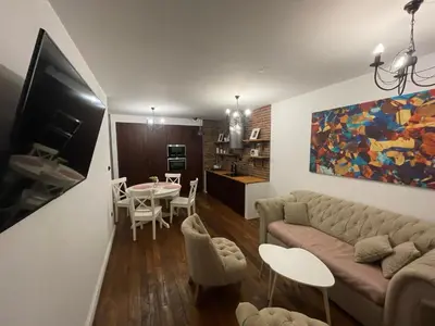 a living room with a couch and a table at Royal Oak - 3BD 2BA apartment with parking and river view in Kraków