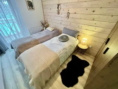 two beds in a room with two cats laying on the floor at Villa Corvo Bianco in Sidzina