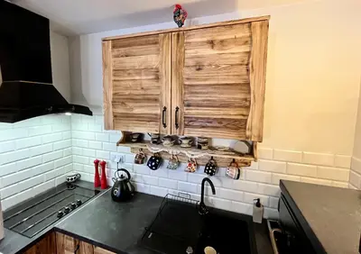 a kitchen with a sink and a wooden cabinet at Villa Corvo Bianco in Sidzina