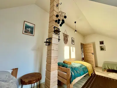 a room with a column in the middle of a bedroom at Villa Corvo Bianco in Sidzina
