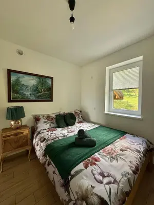 a bedroom with a bed and a window at Apartament Guziczek2 in Nowy Targ