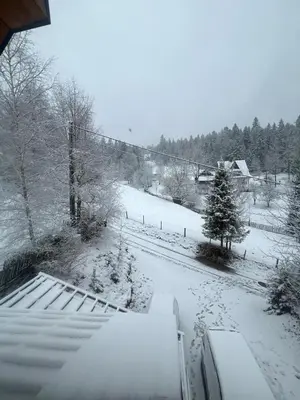 a snow covered yard with a snow covered road at Apartament Guziczek2 in Nowy Targ