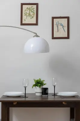 a table with two glasses and a lamp on it at Minimalist One Bedroom Apartment in Kraków Near Wawel by Noclegi Renters in Kraków