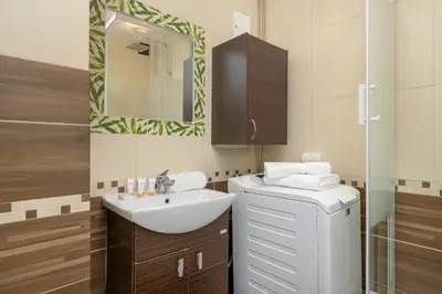 a bathroom with a sink and a mirror at Minimalist One Bedroom Apartment in Kraków Near Wawel by Noclegi Renters in Kraków
