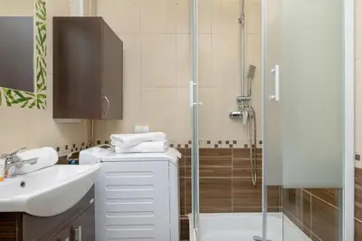 a bathroom with a shower and a sink and a toilet at Minimalist One Bedroom Apartment in Kraków Near Wawel by Noclegi Renters in Kraków