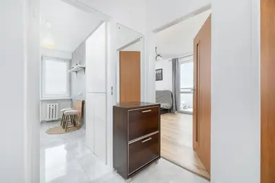 a kitchen with a dresser in the middle of a room at Minimalist One Bedroom Apartment in Kraków Near Wawel by Noclegi Renters in Kraków