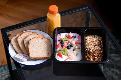 a lunch box with a plate of food and bread at Native Apartments Kościuszki 39/28 in Kraków