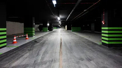 an empty parking garage with orange and green stripes at Native Apartments Kościuszki 39/28 in Kraków