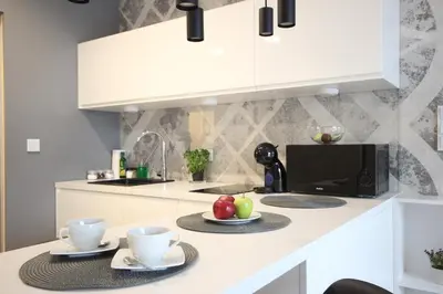 a kitchen with two cups and fruits on a counter at VIVA GREEN & NATUR Apt close to Vistula River - by Homelike Krakow in Kraków