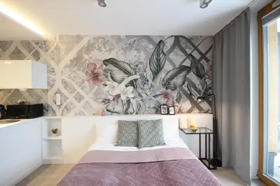 a bedroom with a bed with a floral wallpaper at VIVA GREEN & NATUR Apt close to Vistula River - by Homelike Krakow in Kraków