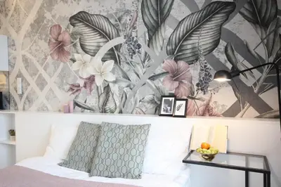 a bedroom with a bed with a floral wallpaper at VIVA GREEN & NATUR Apt close to Vistula River - by Homelike Krakow in Kraków