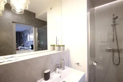 a bathroom with a sink and a mirror and a shower at VIVA GREEN & NATUR Apt close to Vistula River - by Homelike Krakow in Kraków