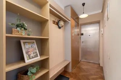a hallway with wooden shelves and a door at Kraków Eagle Pharmacy Studio by Noclegi Renters in Kraków