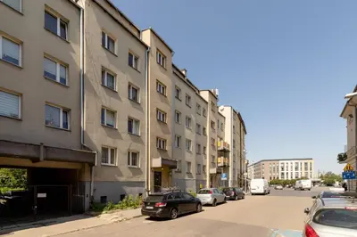 a street with cars parked in front of a building at Kraków Eagle Pharmacy Studio by Noclegi Renters in Kraków