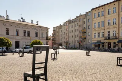 a chair sitting in the middle of a city street at Kraków Eagle Pharmacy Studio by Noclegi Renters in Kraków