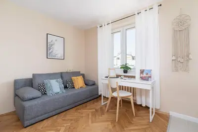a living room with a couch and a table at Kraków Eagle Pharmacy Studio by Noclegi Renters in Kraków