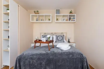 a bedroom with a bed with a table and shelves at Kraków Eagle Pharmacy Studio by Noclegi Renters in Kraków