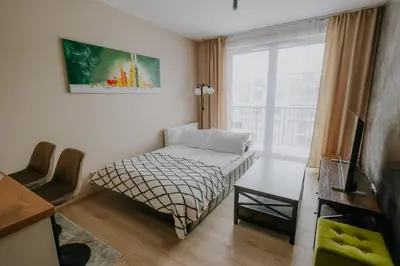 a small bedroom with a bed and a window at Nowy Złocień Comfort Apartment by BookingHost in Kraków