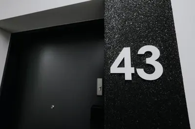 a number on the side of a building at Nowy Złocień Comfort Apartment by BookingHost in Kraków