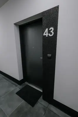 a black door with the number on it at Nowy Złocień Comfort Apartment by BookingHost in Kraków