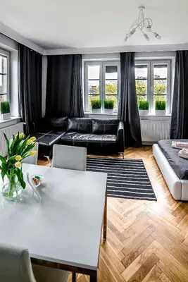 a living room with a couch and a table at Cracovia Apartments in Kraków