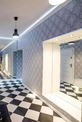 a lobby with a checkered floor and a door at Cracovia Apartments in Kraków