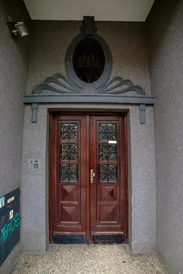 a pair of wooden doors on a building at Cracovia Apartments in Kraków