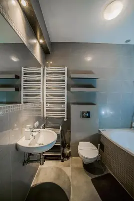 a bathroom with a sink and a toilet and a tub at Cracovia Apartments in Kraków