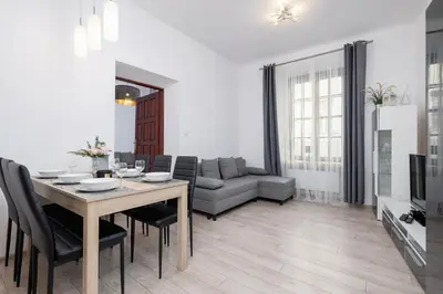 a living room with a table and a couch at Spacious, 2 Bedrooms Apartment Cracow City Centre by Noclegi Renters in Kraków
