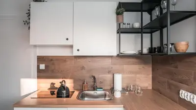 a kitchen with a sink and white cabinets at Pokój Dziupla in Tarnawa Dolna