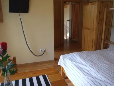 a bedroom with a bed and a tv on the wall at Pokoje i apartamenty pod Jaworzyną w Koninkach in Koninki