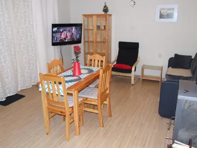 a living room with a table and chairs and a tv at Pokoje i apartamenty pod Jaworzyną w Koninkach in Koninki