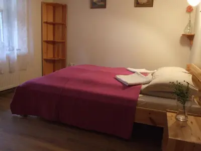 a bedroom with a bed with a purple blanket at Pokoje i apartamenty pod Jaworzyną w Koninkach in Koninki
