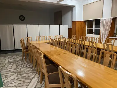 a conference room with a long wooden table and chairs at MODRZEW - noclegi w Pyzówce in PyzÃ³wka