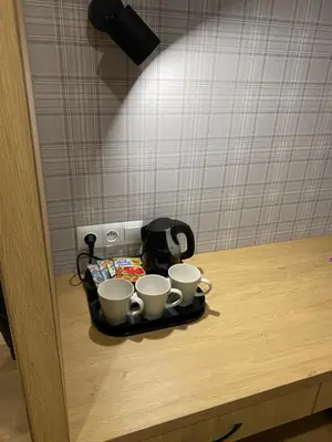 a tray with three coffee cups on a table at MODRZEW - noclegi w Pyzówce in PyzÃ³wka