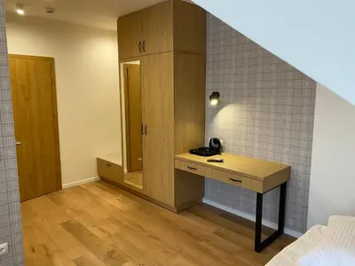 a bathroom with a sink and a mirror in a room at MODRZEW - noclegi w Pyzówce in PyzÃ³wka