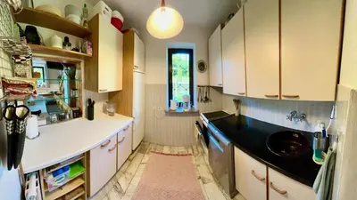 a kitchen with white cabinets and a sink and a window at Przystanek Zawadka in Zawadka