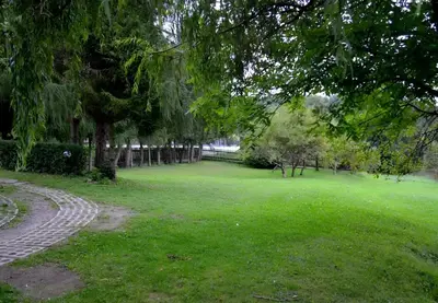 a park with green grass and trees and a path at Przystanek Zawadka in Zawadka