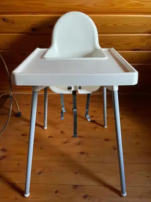 a white table with a chair under it at Przystanek Zawadka in Zawadka