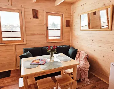 a dining room with a table and a couch at Sielanka u Basi in Toporzysko