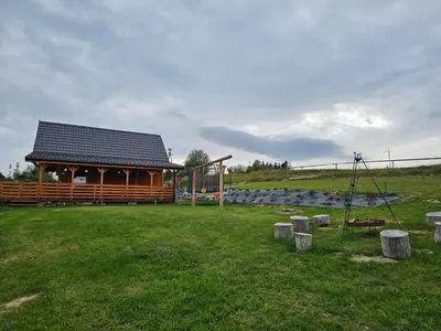 a building with a playground in a field at Sielanka u Basi in Toporzysko
