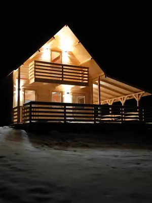 a house with lights on the side of it at night at Sielanka u Basi in Toporzysko