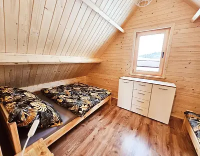 a bedroom with two beds and a window at Sielanka u Basi in Toporzysko