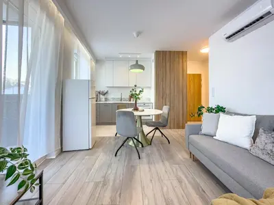 a living room with a couch and a table at Krakowska Oaza Komfortu - Apartament Premium z Garażem in Kraków