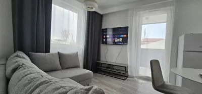 a living room with a couch and a tv at Krakowska Oaza Komfortu - Apartament Premium z Garażem in Kraków