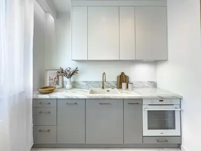 a white kitchen with white cabinets and a sink at Krakowska Oaza Komfortu - Apartament Premium z Garażem in Kraków