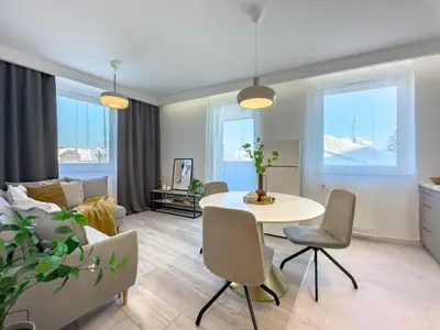 a living room with a table and a couch at Krakowska Oaza Komfortu - Apartament Premium z Garażem in Kraków