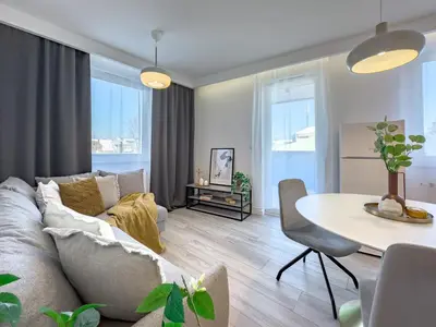 a living room with a couch and a table at Krakowska Oaza Komfortu - Apartament Premium z Garażem in Kraków