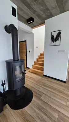 a fireplace in a living room with a wood floor at Tarnova Chill in Tarnawa